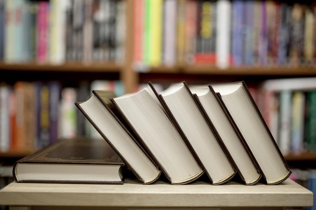 books stacked on a table in a library