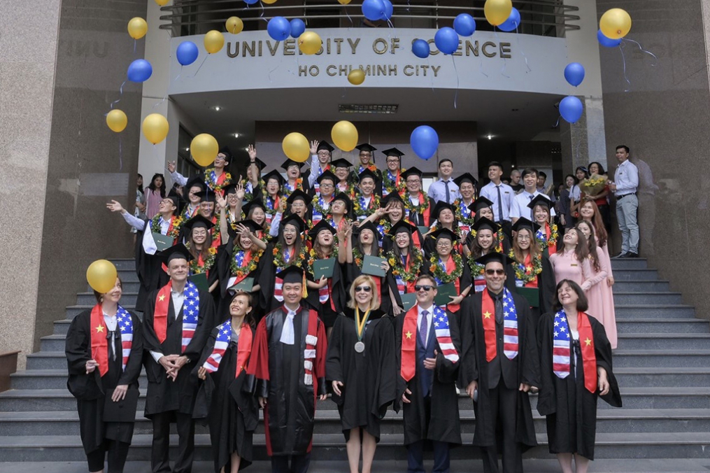 Keuka College Vietnam Program Graduates Celebrate by throwing balloons up in the air