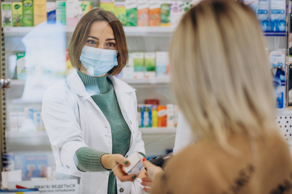 Pharmacist waiting on a customer at a pharmacy