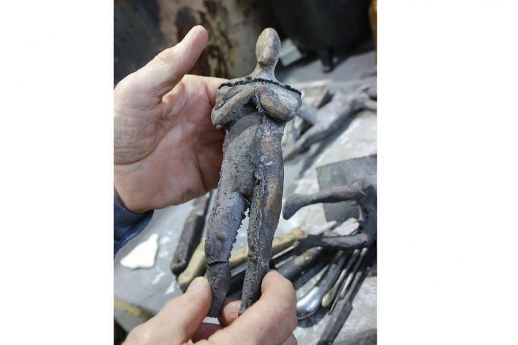 Sculptor Dexter Benedict holds a figure that survived the fire at Fire Works Foundry Nov. 1, 2017.