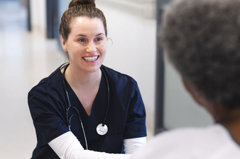 Nurse smiles at patient.